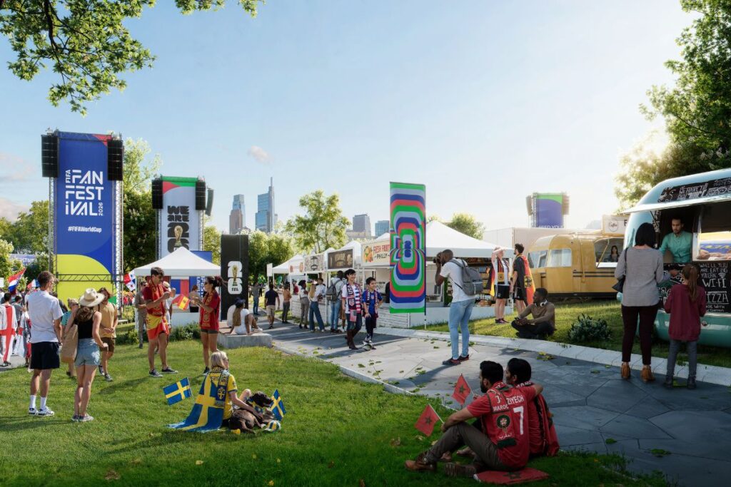 Se ven fanáticos de diferentes países sentados en el césped y caminando entre food trucks, carpas blancas y pantallas gigantes, con el skyline de Philadelphia al fondo.
